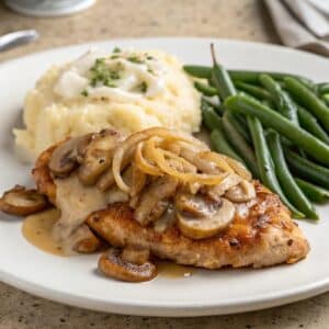 Texas Roadhouse smothered chicken served with classic sides