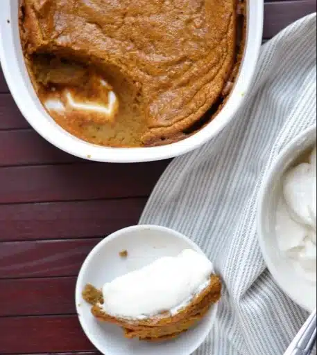 Baked Pumpkin Spice Pudding: A Heartwarming Fall Delight to Try 1 Delicious baked pumpkin spice pudding topped with whipped cream and spices