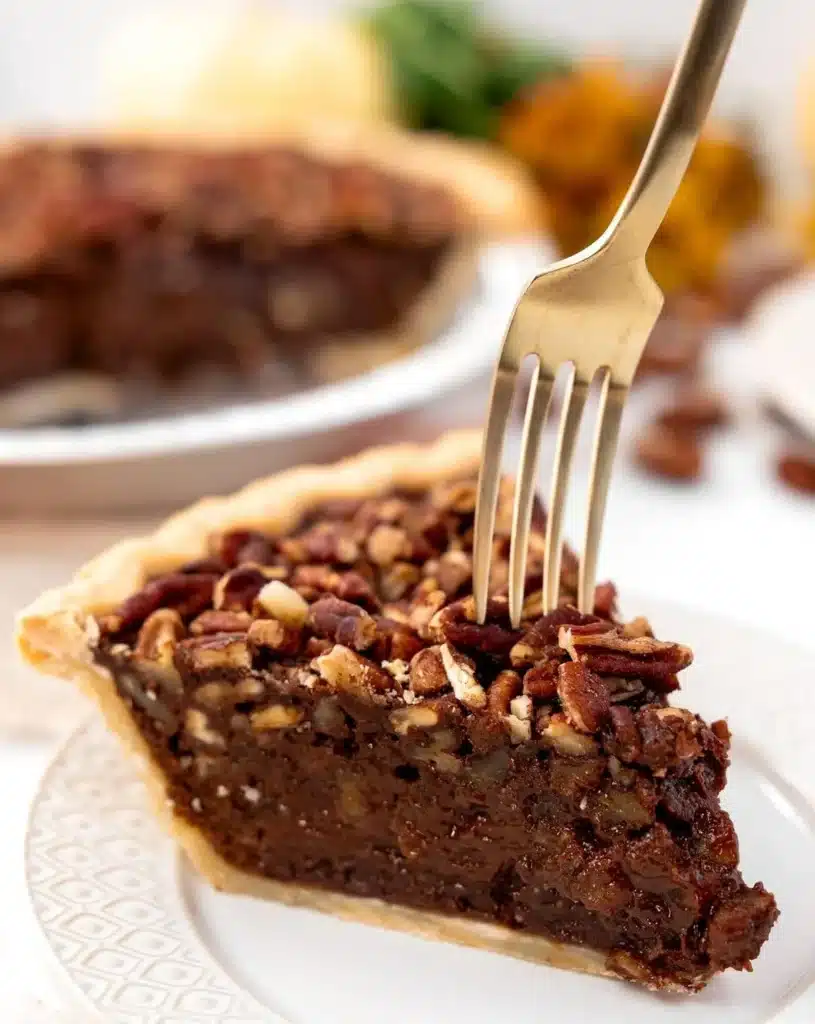 Delicious Texas Chocolate Pecan Pie topped with pecans and rich chocolate filling